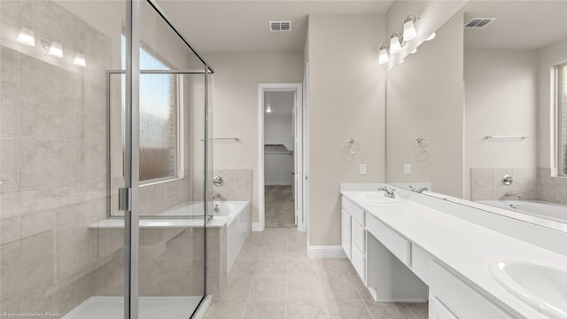 bathroom with independent shower and bath, vanity, and tile patterned floors