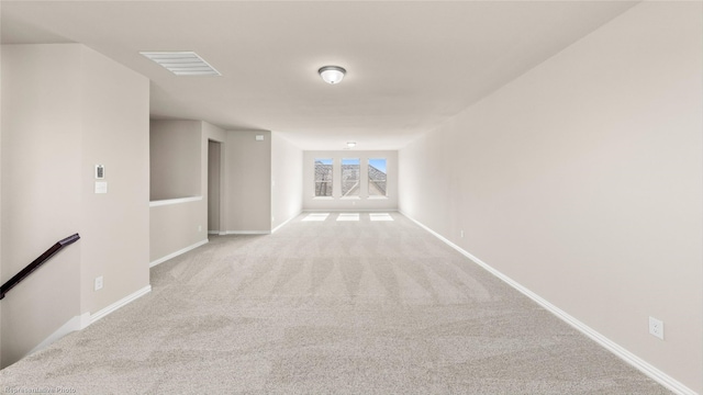 corridor featuring light carpet