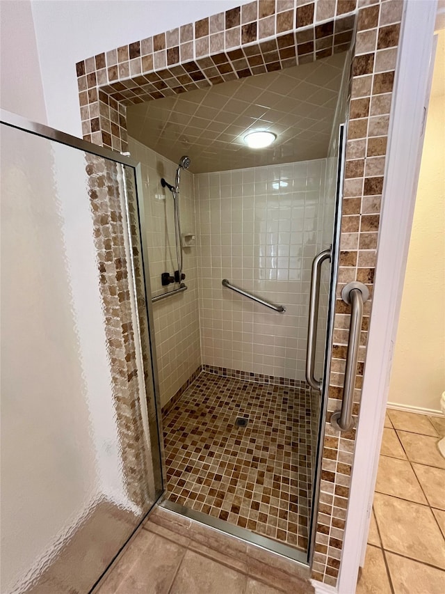 bathroom with walk in shower and tile patterned floors