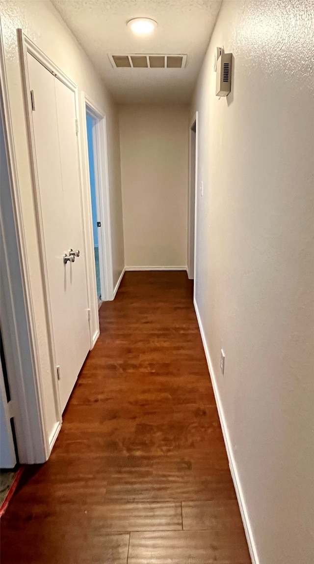 hall with dark hardwood / wood-style flooring