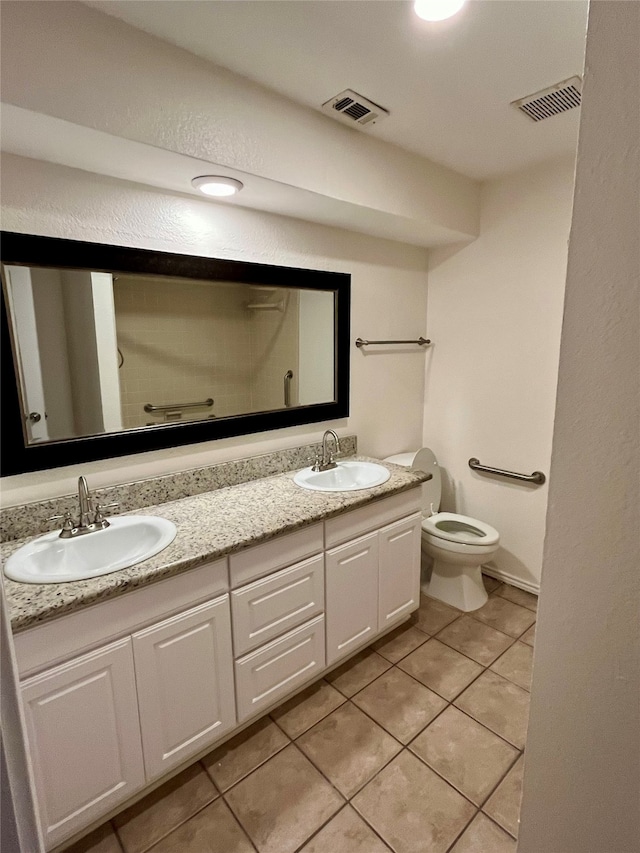 bathroom featuring tile patterned floors, vanity, and toilet