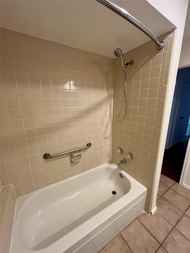 bathroom with tiled shower / bath combo and tile patterned floors