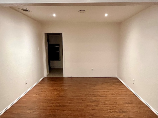 spare room with dark wood-type flooring