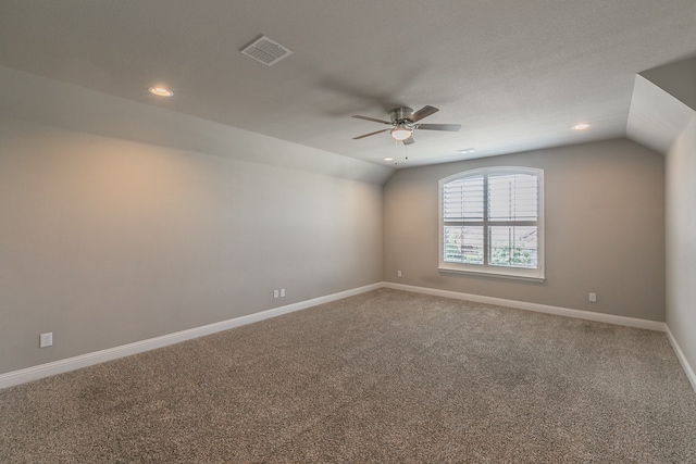 unfurnished room with ceiling fan, carpet flooring, and vaulted ceiling