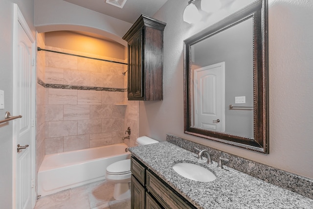 full bathroom with tiled shower / bath combo, vanity, toilet, and tile patterned floors