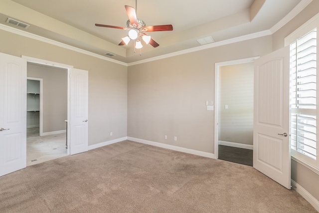 unfurnished bedroom with ceiling fan, light colored carpet, and multiple windows