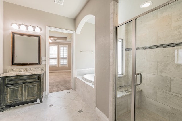 bathroom featuring vanity, ceiling fan, plus walk in shower, and tile patterned floors