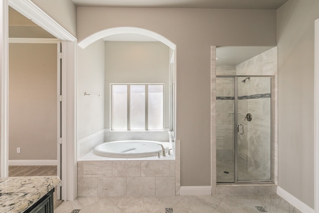 bathroom featuring independent shower and bath and vanity