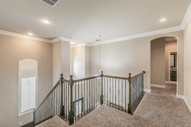 staircase featuring ornamental molding and carpet flooring