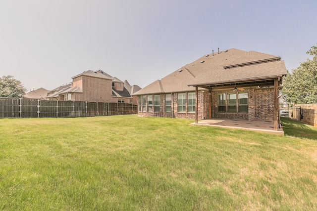 exterior space featuring a lawn and a patio area