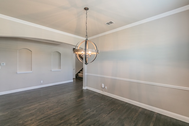 empty room featuring ornamental molding, dark wood-type flooring, and a notable chandelier