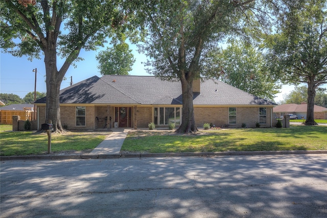 single story home featuring a front yard