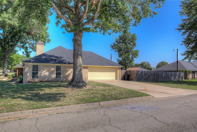 view of front of home with a front lawn and a garage