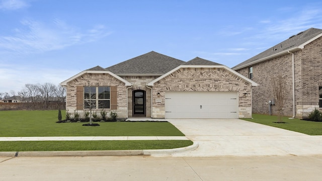 view of front of house featuring a garage and a front yard