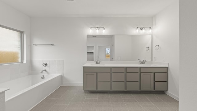 bathroom with vanity, a bath, and tile patterned flooring