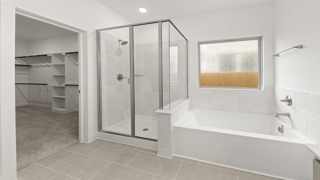 bathroom with tile patterned floors and independent shower and bath