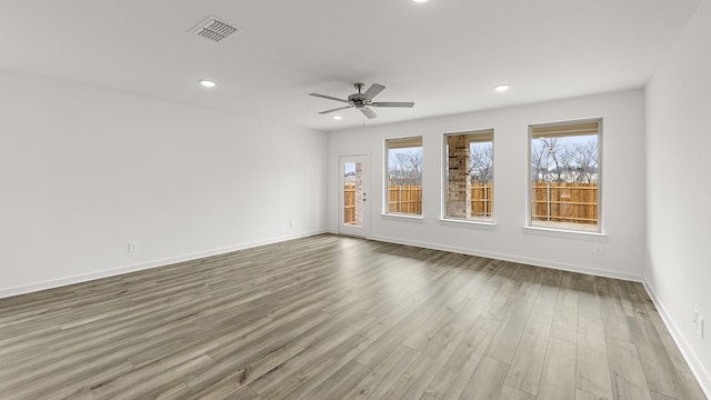 unfurnished room with hardwood / wood-style flooring and ceiling fan