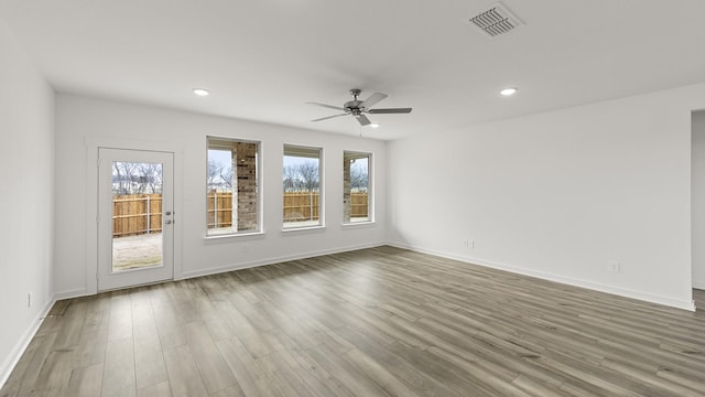 spare room featuring hardwood / wood-style floors and ceiling fan