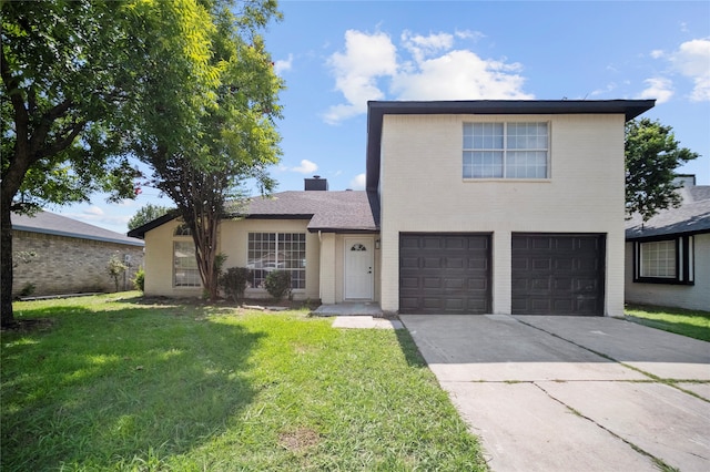 front of property featuring a front lawn and a garage