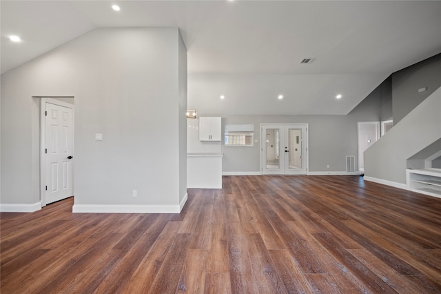 unfurnished living room with high vaulted ceiling and dark hardwood / wood-style flooring