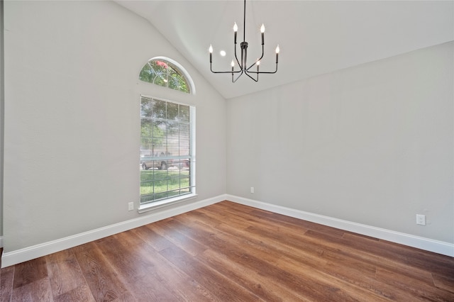 interior space featuring a notable chandelier, lofted ceiling, plenty of natural light, and hardwood / wood-style floors