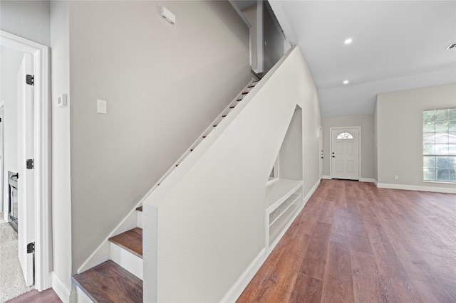 staircase with wood-type flooring