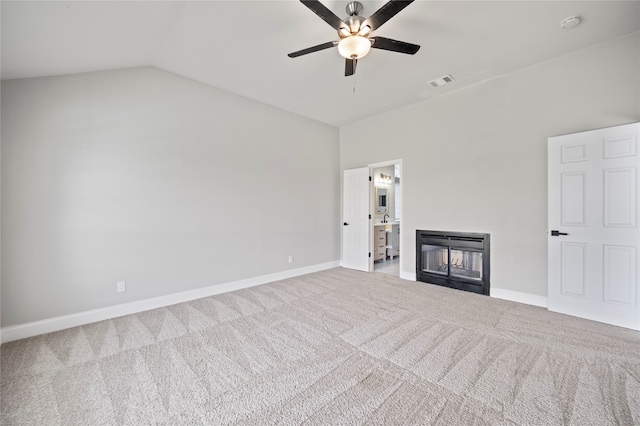 unfurnished living room featuring lofted ceiling, a multi sided fireplace, ceiling fan, and carpet flooring