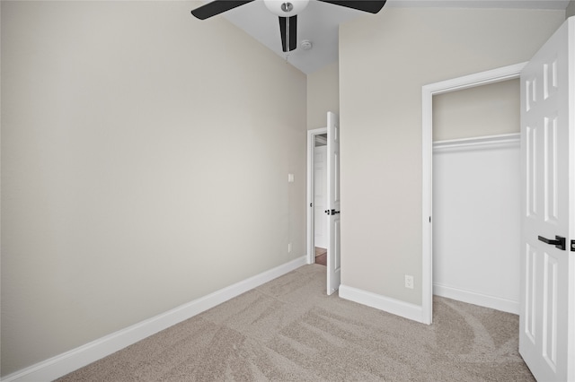 unfurnished bedroom featuring ceiling fan, light colored carpet, and a closet