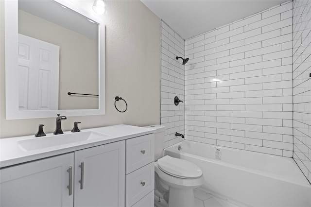 full bathroom featuring tiled shower / bath combo, vanity, and toilet