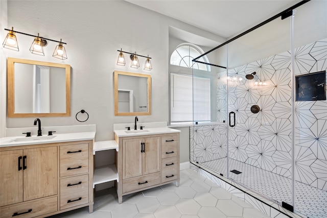 bathroom with tile patterned floors, an enclosed shower, plenty of natural light, and vanity