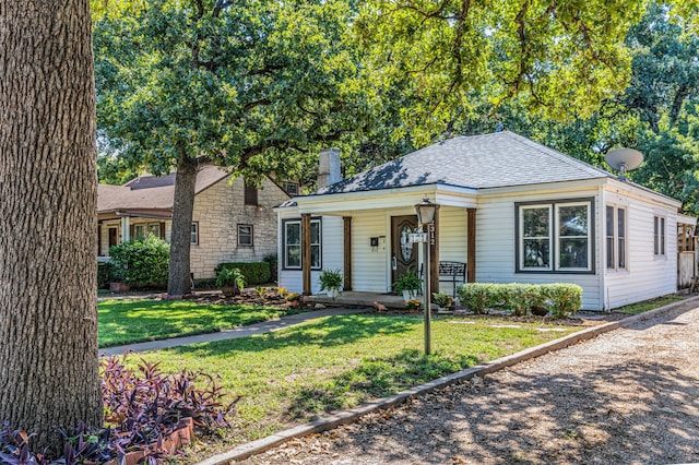 view of front of home with covered porch and a front yard