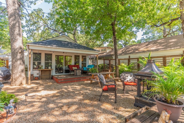 view of patio featuring a deck and a sunroom