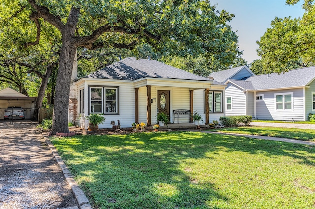 ranch-style house with a porch and a front lawn