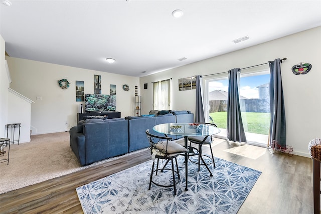 dining space with hardwood / wood-style floors