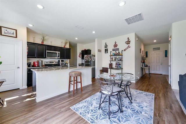 dining space featuring wood-type flooring