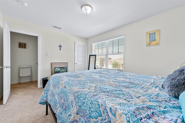 bedroom featuring light colored carpet