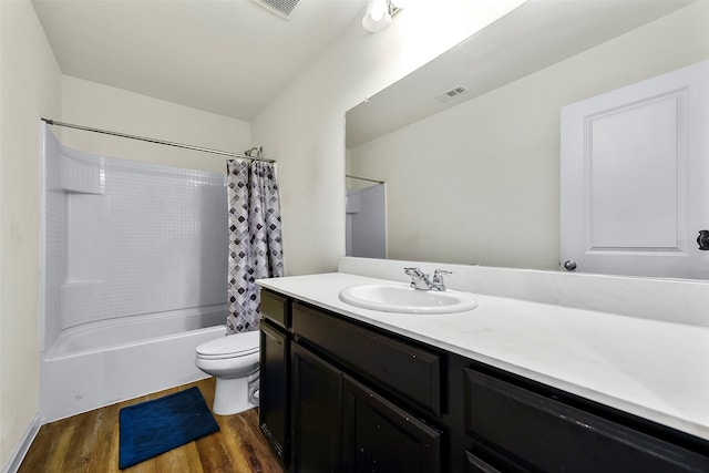 full bathroom with vanity, hardwood / wood-style flooring, shower / tub combo, and toilet