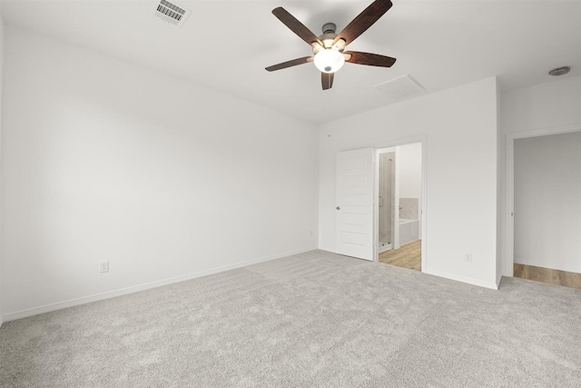 unfurnished bedroom with light carpet, ensuite bath, and ceiling fan