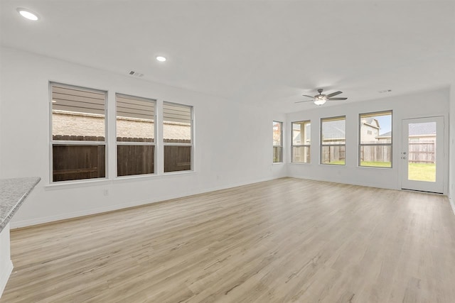 unfurnished living room featuring ceiling fan and light hardwood / wood-style floors