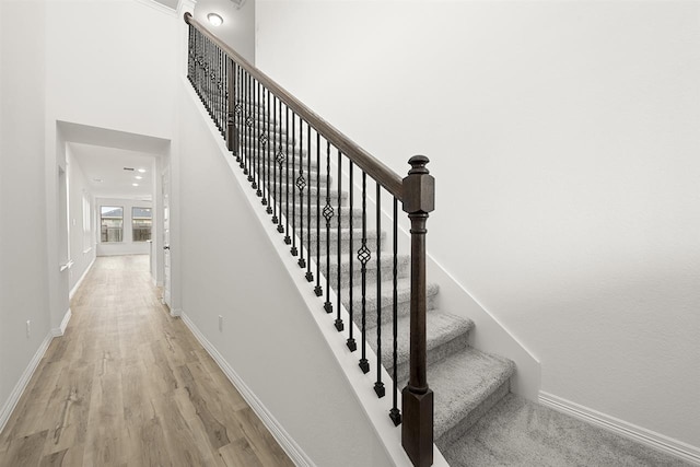 stairway with hardwood / wood-style floors