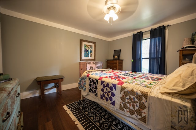 bedroom featuring ornamental molding, ceiling fan, and dark hardwood / wood-style flooring