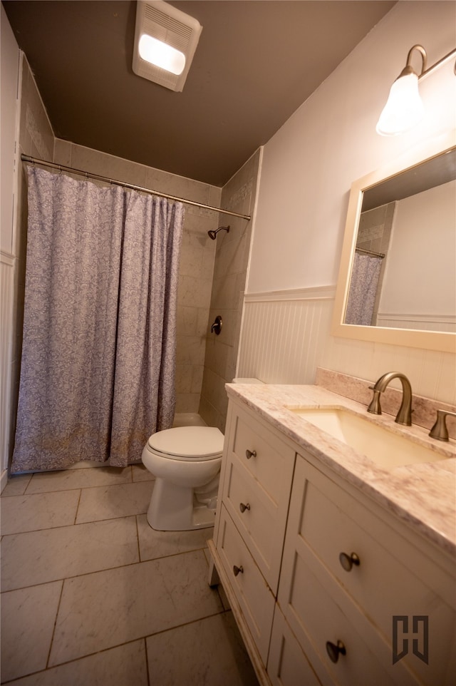 bathroom featuring curtained shower, vanity, toilet, and tile patterned floors