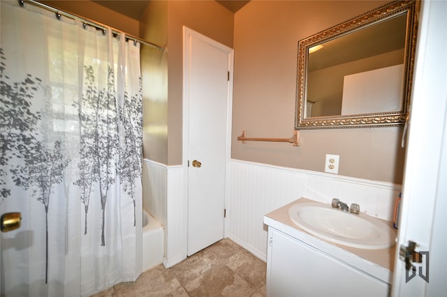 bathroom featuring shower / bath combination with curtain and vanity