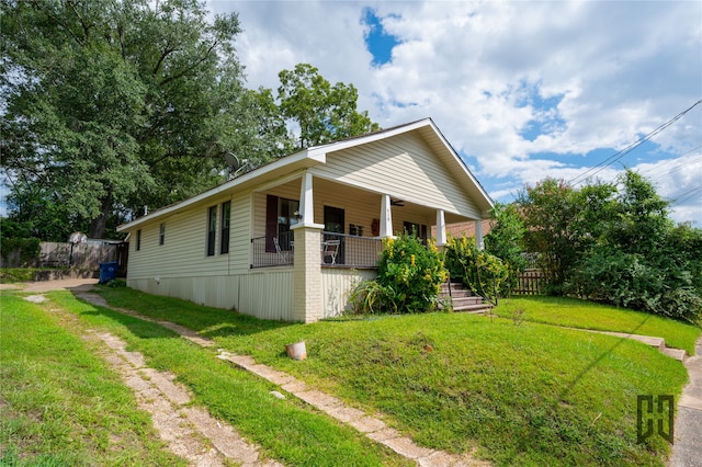 view of side of home with a lawn