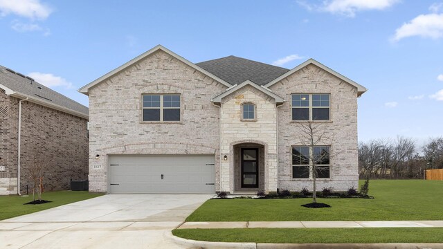 view of front of property with a garage and a front yard