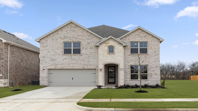 view of front of house featuring brick siding, roof with shingles, concrete driveway, an attached garage, and a front yard