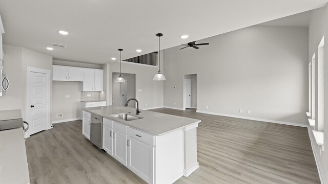 kitchen featuring blue cabinetry, stainless steel appliances, sink, and light hardwood / wood-style flooring