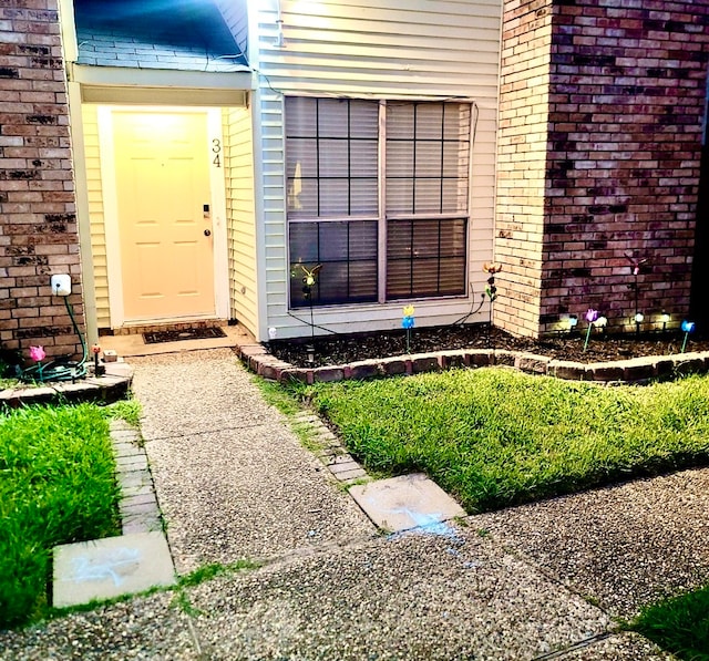 entrance to property with brick siding