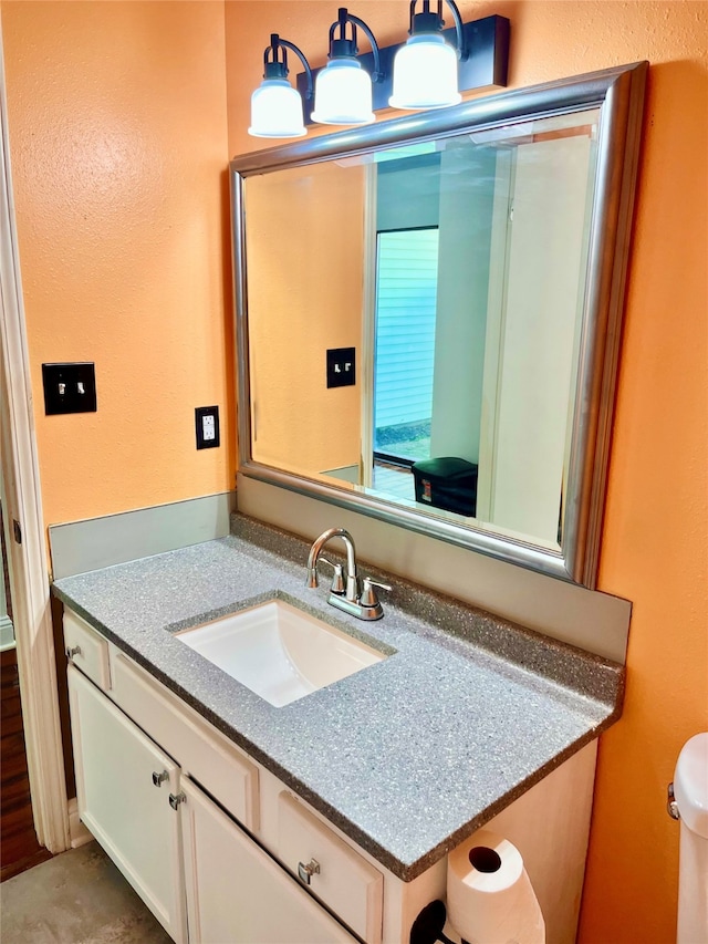 bathroom featuring vanity and toilet