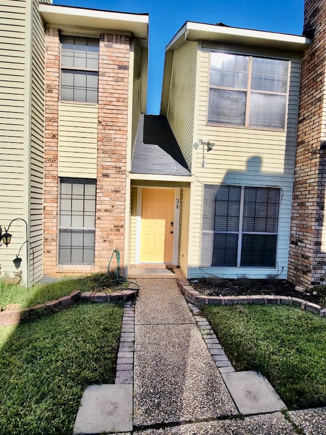 view of exterior entry with brick siding